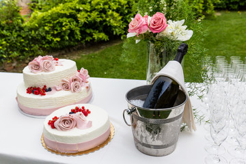 White wedding cake with red fruits.
