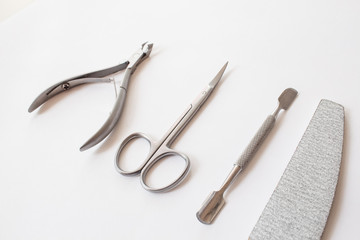  set of tools for manicure on a white background close-up. top view, text space.