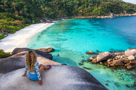 Young female stand on viewpoint sailing rock in Similan island. Freedom traveler woman enjoy a wonderful nature on Similan No.8 at Similan national park, Phuket, Thailand. Travel concept