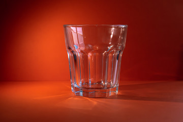 Empty glass on an orange background