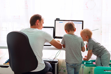 Father with kids working from home during quarantine. Stay at home, work from home concept during...