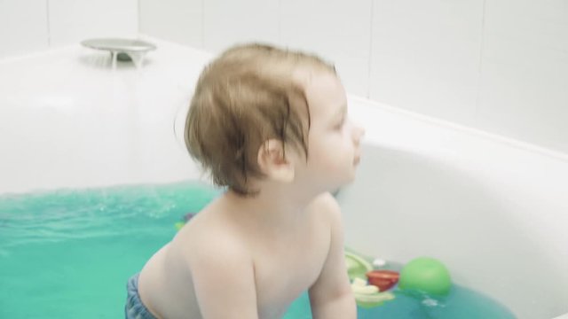 Boy child bathes in bath