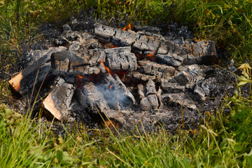 The fading fire on the grass in hot day.