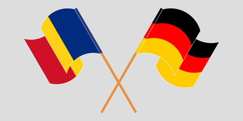 Crossed and waving flags of Romania and Germany