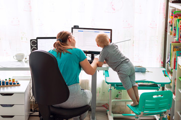 Mother with kid working from home during quarantine. Stay at home, work from home concept during...