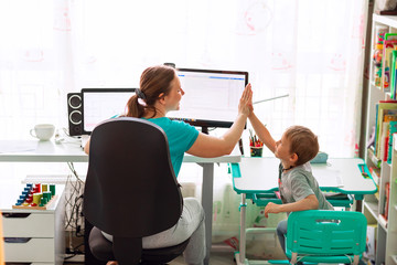 Mother with kid working from home during quarantine. Stay at home, work from home concept during...