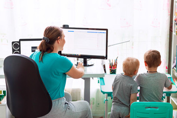 Mother with kids working from home during quarantine. Stay at home, work from home concept during...
