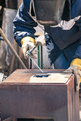 Metal welding by a manual electric welding machine.
