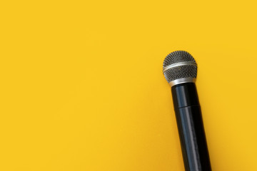 microphone and copy space on yellow background, singing, interview concept
