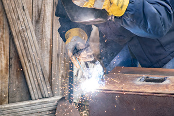 Metal welding by a manual electric welding machine.