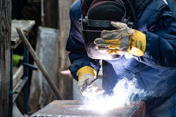 Metal welding by a manual electric welding machine.
