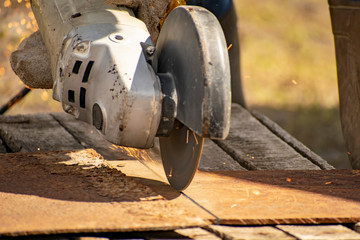 Metal processing with a manual electric grinder.