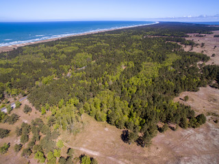 Aerial view with dunes, forest and sea in Curonian spit on a sunny day photographed with a drone. The Curonian Spit lagoon. Gray Dunes, Dead Dunes. 