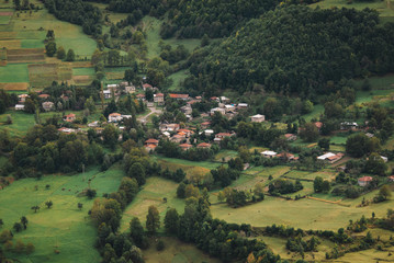 Fototapeta na wymiar Green village by the mountain