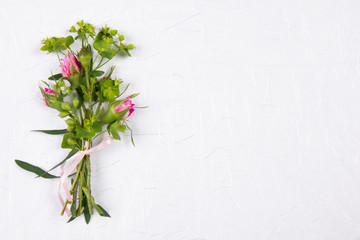 White background with a bouquet of flowers and place for text.