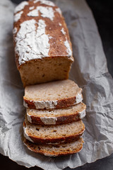Fragrant and crunchy sliced bread on parchment in the kitchen. Homemade fresh bread without yeast.