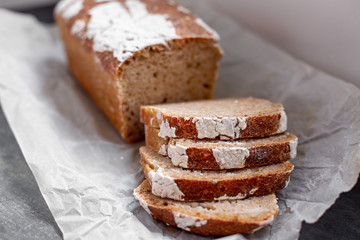 Fragrant and crunchy sliced bread on parchment in the kitchen. Homemade fresh bread without yeast.