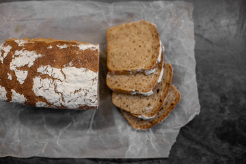 Fragrant and crunchy sliced bread on parchment in the kitchen. Homemade fresh bread without yeast.