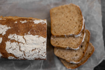 Fragrant and crunchy sliced bread on parchment in the kitchen. Homemade fresh bread without yeast.