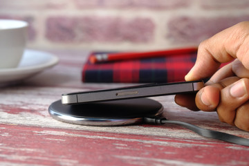 charging Smartphone Using Wireless Charging Pad, top view 