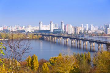 Fototapeta premium View of the Dnieper River in the city of Kiev. Potona Bridge and the modern buildings of the city. 