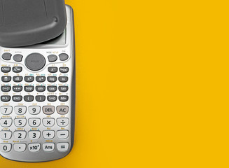 calculator on yellow background in business concept, copy space