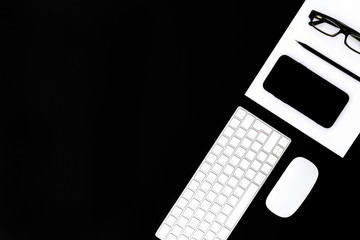 Office supplies on black background.