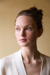 Studio shot of young cute woman isolated on beige