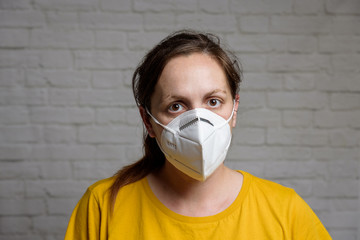 Young woman wearing KN-95 protection medical mask. Prevention of the spread of virus and epidemic, protective mouth filter mask. Diseases, flu, air pollution, corona virus concept