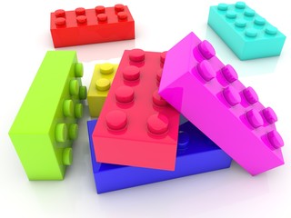 Colored toy bricks scattered on a white background