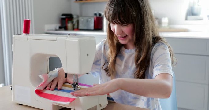 Girl Stitching Fabric Using Sewing Machine At Home