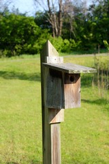 A close view of the wood box birdhouse.