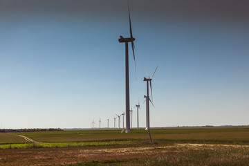 Obraz premium Windmill for electric power production, France. Blue sky