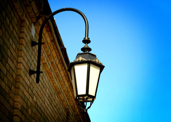Fototapeta na wymiar Street hanging lantern on a brick wall. 