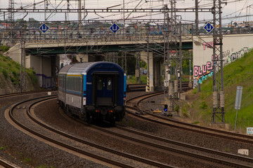 Fototapeta premium the train passes through the city on tracks in prague in the czech republic
