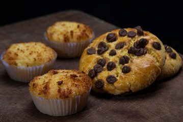 Beautiful loaves and pastries in low light on black background