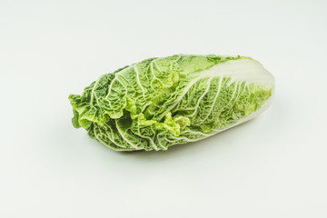 A head of fresh Peking cabbage on a light background. Raw food.