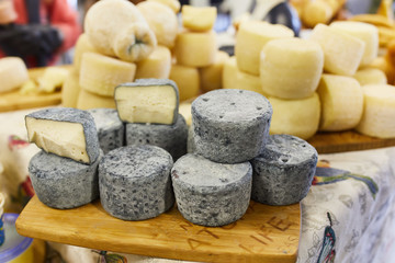 Different types of homemade goat cheese are sold on the counter