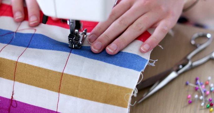 Close Up Of Teenage Girl Stitching Fabric With Sewing Machine At Home