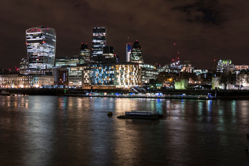 Fototapeta na wymiar Night photo of London with illuminated skyscrapers 