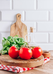 Olive oil, tomato and basil on rustic wooden table. Italian cuisine concept. Ready for cook