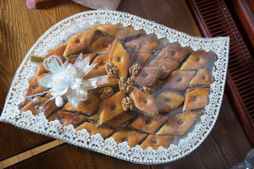 Basket with sweets stands on the table . Engagement accessories . Engagement basket .
