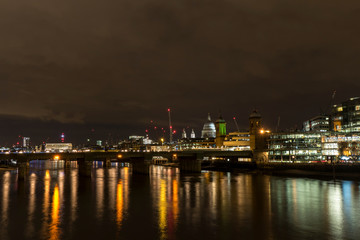 Fototapeta na wymiar Night photo of London with illuminated Thames and building with many lights