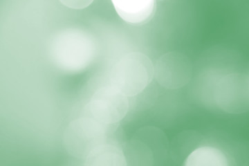 Defocused abstract background green lights. The theme of ecology, healthy lifestyle. Medicine, science, technology. Rod designer abstraction for writing of the text. Shiny, shine, background.