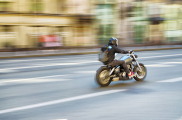Obraz na płótnie Canvas Fast motorcycle riding around the city.