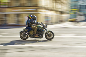 Fast motorcycle riding around the city.