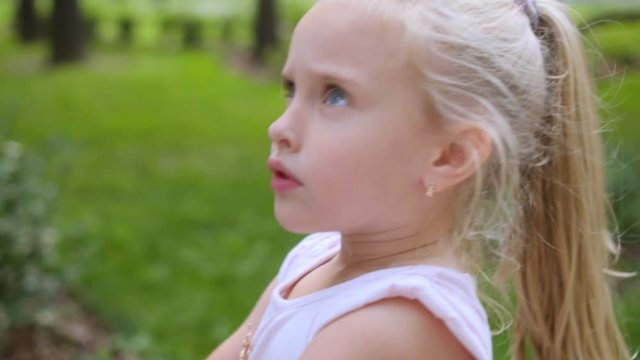 charming tired 5 year old blondy girl is naughty, upset, shows tongue