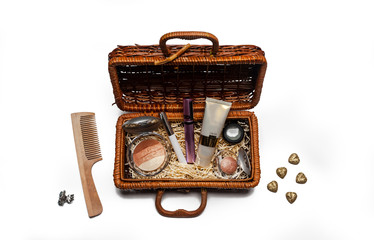 wooden wicker box with cosmetics isolated on white. Cream, mascara, shadows in a rattan gift box. Natural makeup and skin care concept