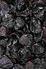 Prunes, withered plums background. Heap of dried fruits
