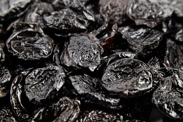Prunes, withered plums background. Heap of dried fruits